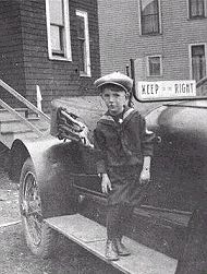 Photograph of a car with "Keep to the Right" sign mounted on the windshield as a reminder to oncoming drivers.